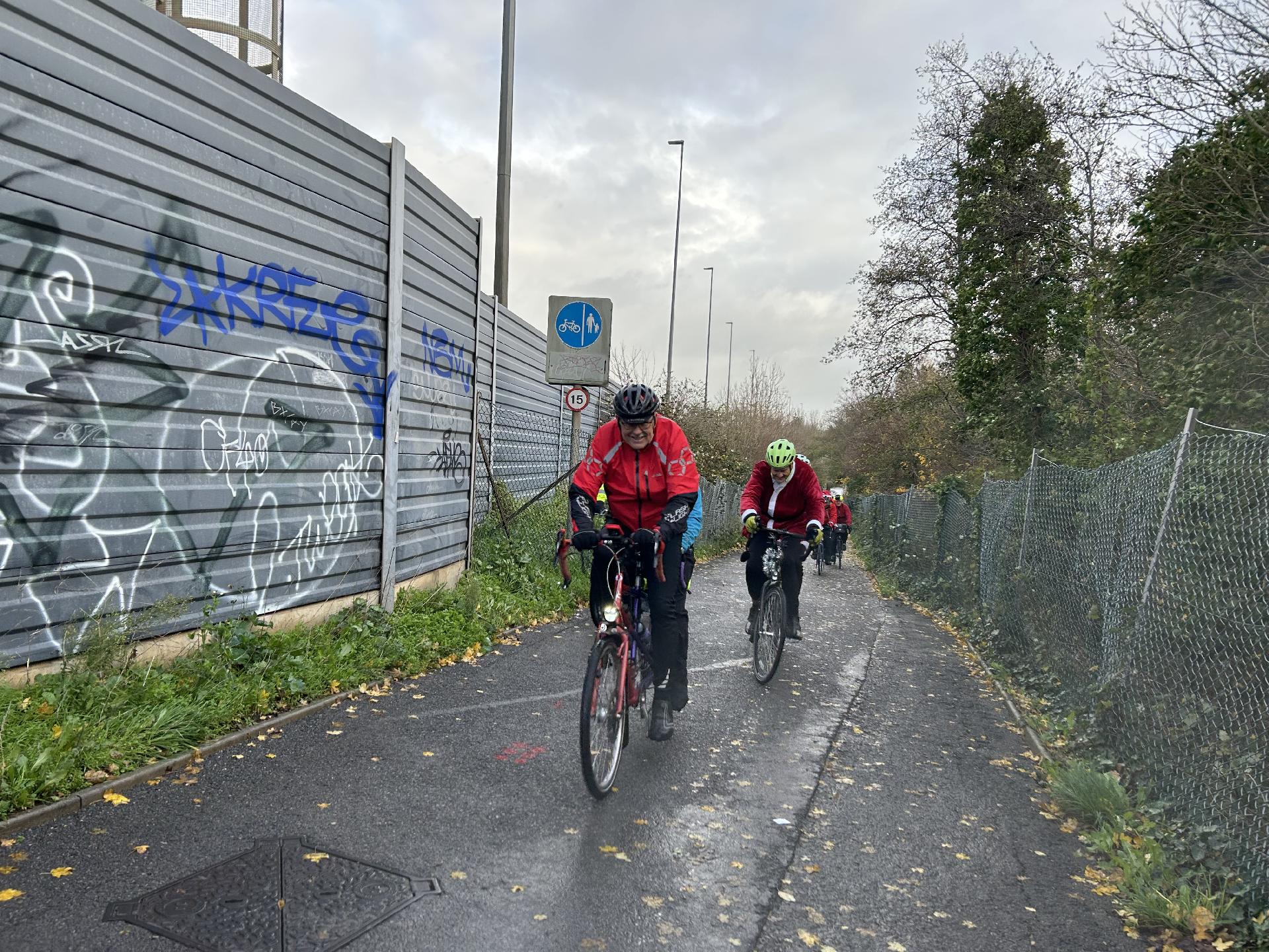 Paul and Nell Buckley followed by Simon Elliott heading over the long bridge over River Avon, very windy